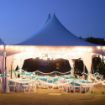 20' x 20' Square Matrix rental tent configured with soft white globe lights over tables set for a wedding.
