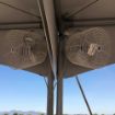 Two Versa-Kool 12" Tent Fans shown mounted on a rental tent corner support pole.