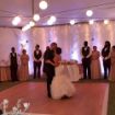Couple dancing on 12' x 12' rental dance floor under a lighted tent ceiling.