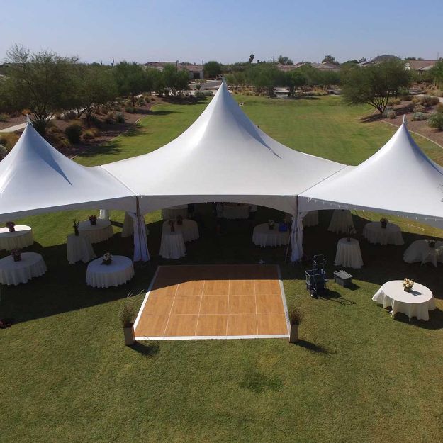 Wood 15' x 16' dance floor setup next to three tent in a dancing under the stars configuration.