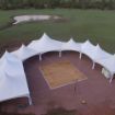 Huge dancing under the stars wedding tent configuration with a 28' x 30' wooden dance floor under the outdoor hanging lights.