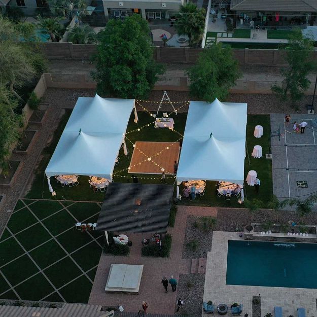 Outdoor party with an 18' x 20' wood dance floor configured between 4 tents.