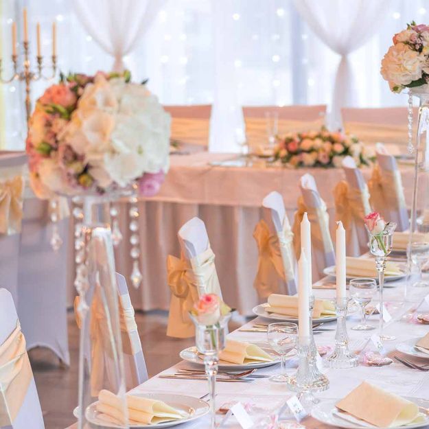 White linen rectangle table cloths elegantly placed on 6' banquet tables displaying floor length option.