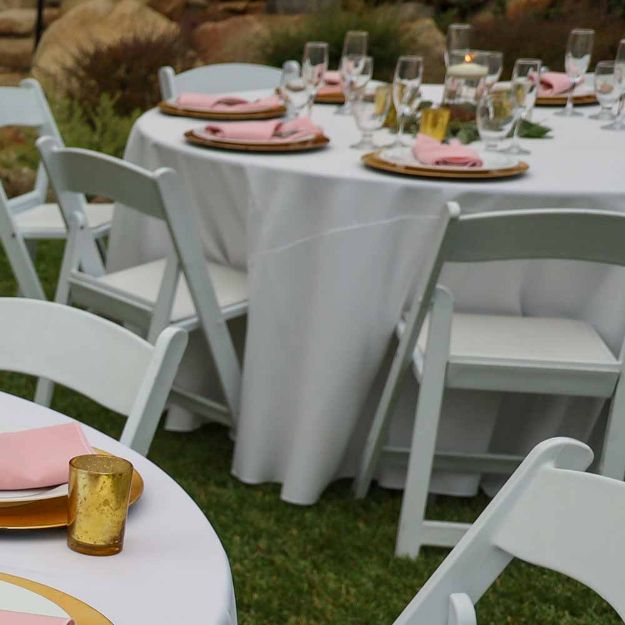 Round 108" white linen table cloth elegantly set up for a wedding celebration.