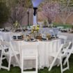 Round 120" white linen table cloth elegantly set up for a wedding celebration.