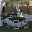 Black decorative square linen overlay on a 48" round rental table with a white table cloth.