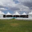 Wedding ceremony chairs set up in front of a Dancing Under the Stars package on a grass lawn.