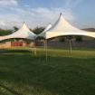 Mini Dancing Under the Stars canopy set up on a grass lawn prior to adding tables, chairs and decorations.
