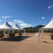 Mountain backdrop with a Dancing Under the Stars 420 Wedding Tent Package ready to decorate for the reception.