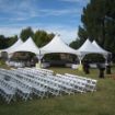 Backyard wedding ceremony and reception setup using a Hexagon 170 rental tent package.