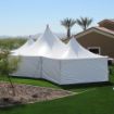 Three sides of a Hexagon 125 rental tent covered with solid sidewalls to protect guest from the sun.