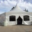 A Hexagon 60 wedding tent with solid side walls and a door and window sidewall entrance.