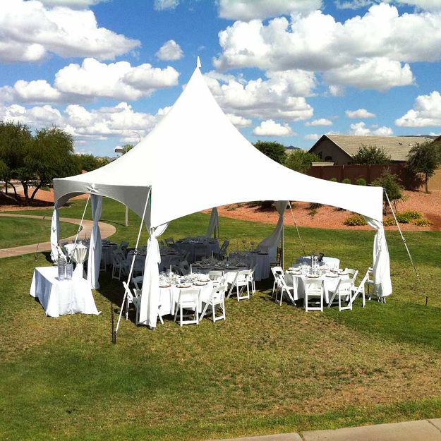 Wedding reception for 32 guests elegantly decorated under a JMS 20' x 30' rental tent with guest tables and chairs.