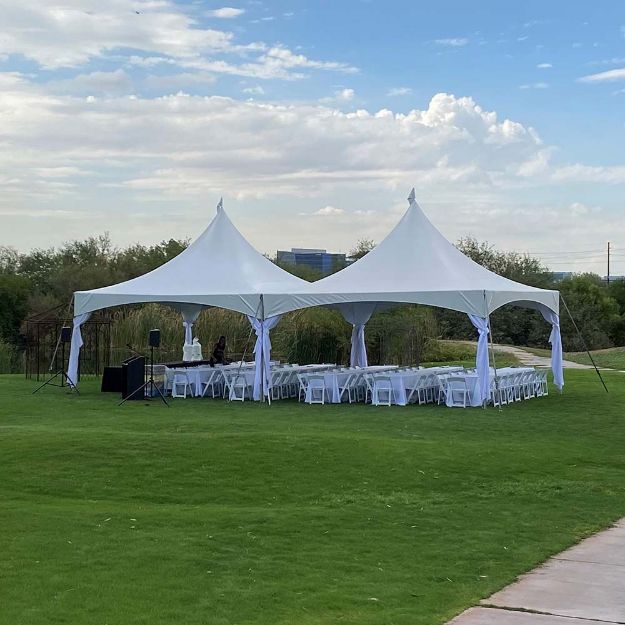 20' x 40' Rectangular tent with banquet style guest tables, chairs, a podium and sound system setup at Singh Meadows, Tempe