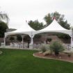 Basketball court with a 20' x 40' Rectangular Tent erected and in the process of being decorated for a wedding reception.