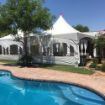 Elegant backyard wedding with a 20'x 40' Rectangle Tent featuring window sidewalls looking over a crystal blue pool.