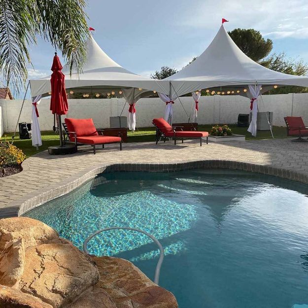 With a pool in the foreground, a 20' x 50' Rectangle Wedding Tent Package is ready for decorations and guests.