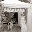 Bride gracefully exiting a 10' x 10' pop-up tent canopy with the word carnival hanging above and a young boy following with an umbrella.