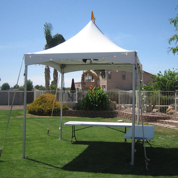 10' x 10' Matrix Rental Tent set up on the grass in a backyard.