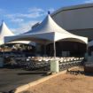 Two fully configured backyard tent rental packages for 48 guests setup in a corporations parking lot.