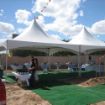 20' x 40' Groundbreaking Rental Package with cocktail tables and a buffet table setup featuring white linens.