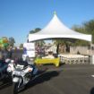 Police motorcycle in the foreground of a Grand Opening Tent Package before an event.