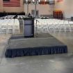 8' x 8' modular event stage with two 4' x 8' decks connected show from behind a podium setup for an event.