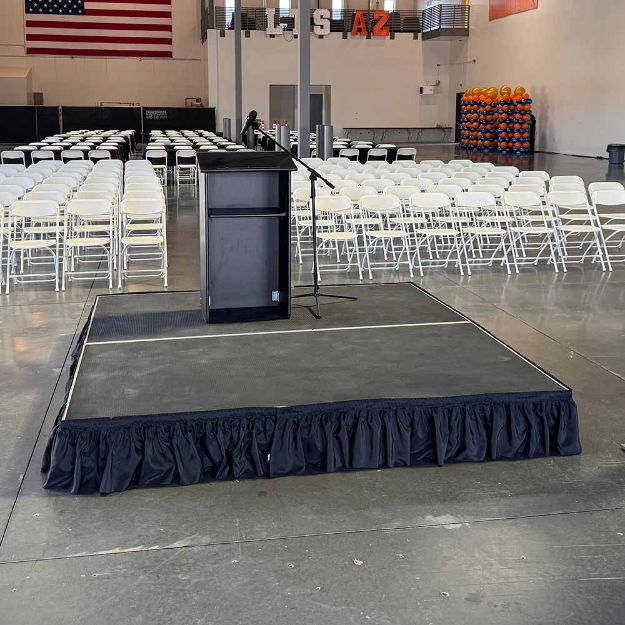 8' x 8' modular event stage with two 4' x 8' decks connected show from behind a podium setup for an event.
