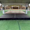 12' x 16' modular event stage with two 4' x 8' decks connected show from behind a podium setup for an event.