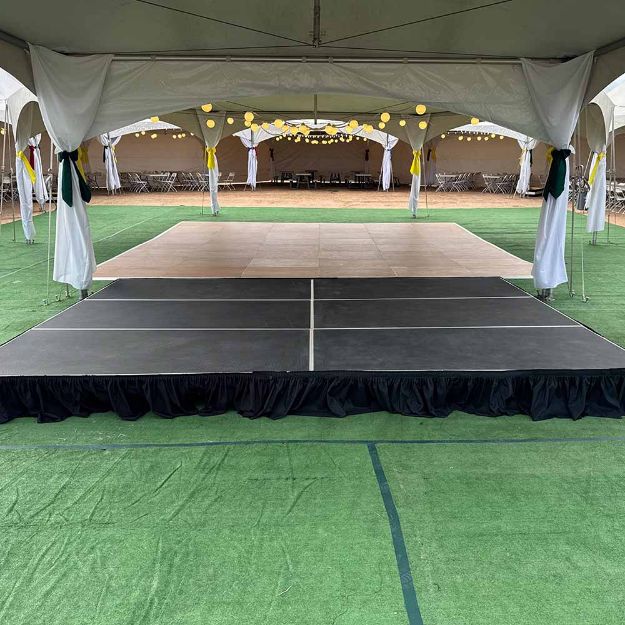 12' x 16' modular event stage with two 4' x 8' decks connected show from behind a podium setup for an event.